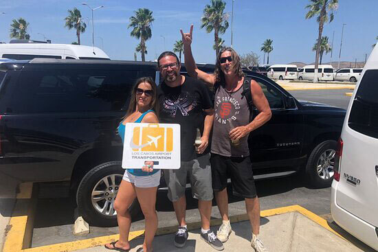 Group of three friends about to enjoy a ride in a black Suburban luxury SUV | Cabo Airport Transportation